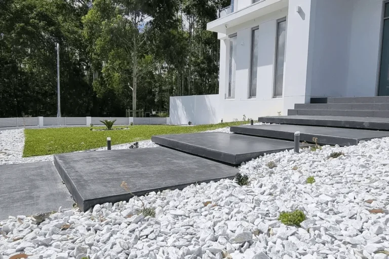 Modern Landscaping Turramurra in Turramurra by Arianya, with grey stone steps, white pebbles, and green lawn, showcasing expert outdoor design.