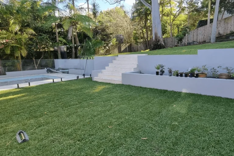 Landscaping Turramurra at Yeramba St, Turramurra, Sydney, by Arianya, with modern retaining walls, green lawn, and steps, reflecting expert design.