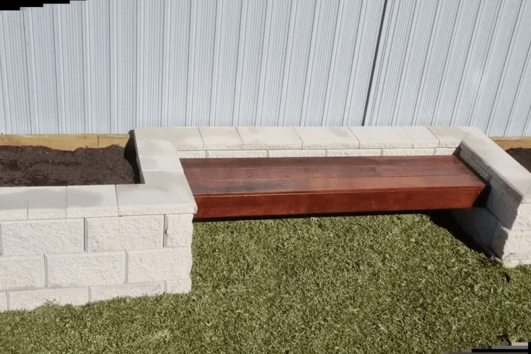 A stylish timber bench in Berala, Sydney, by Arianya, with a wooden seat on white block garden beds and green turf, highlighting expert landscaping skills.