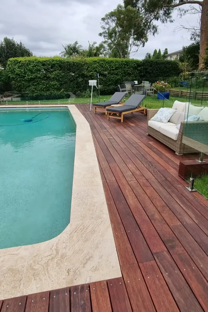 Poolside timber decking with lounge chairs, showcasing stylish outdoor deck ideas by Arianya.