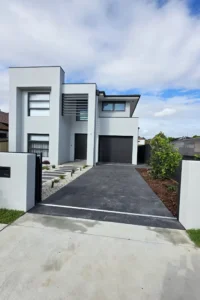 Modern concrete driveway installation in Sydney by Arianiya Landscapes.