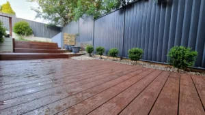 Modern backyard with timber decking and garden edging, showcasing stylish Sydney deck ideas.