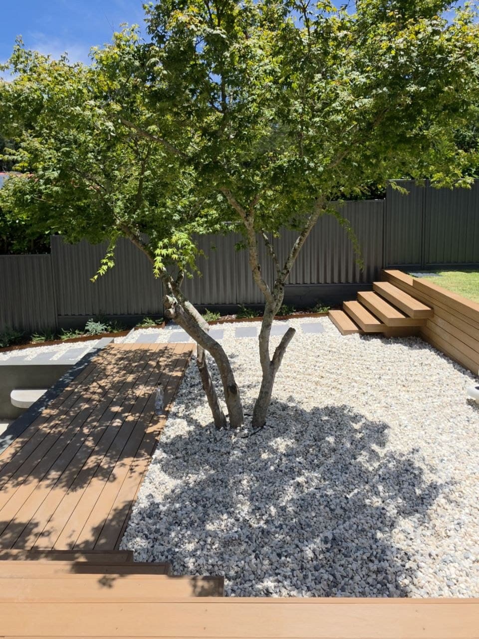 Large stepping-stone path through a landscaped front yard